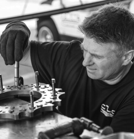 Maintenance technician inspecting industrial equipment on the plant floor, a common path to the maintenance manager role