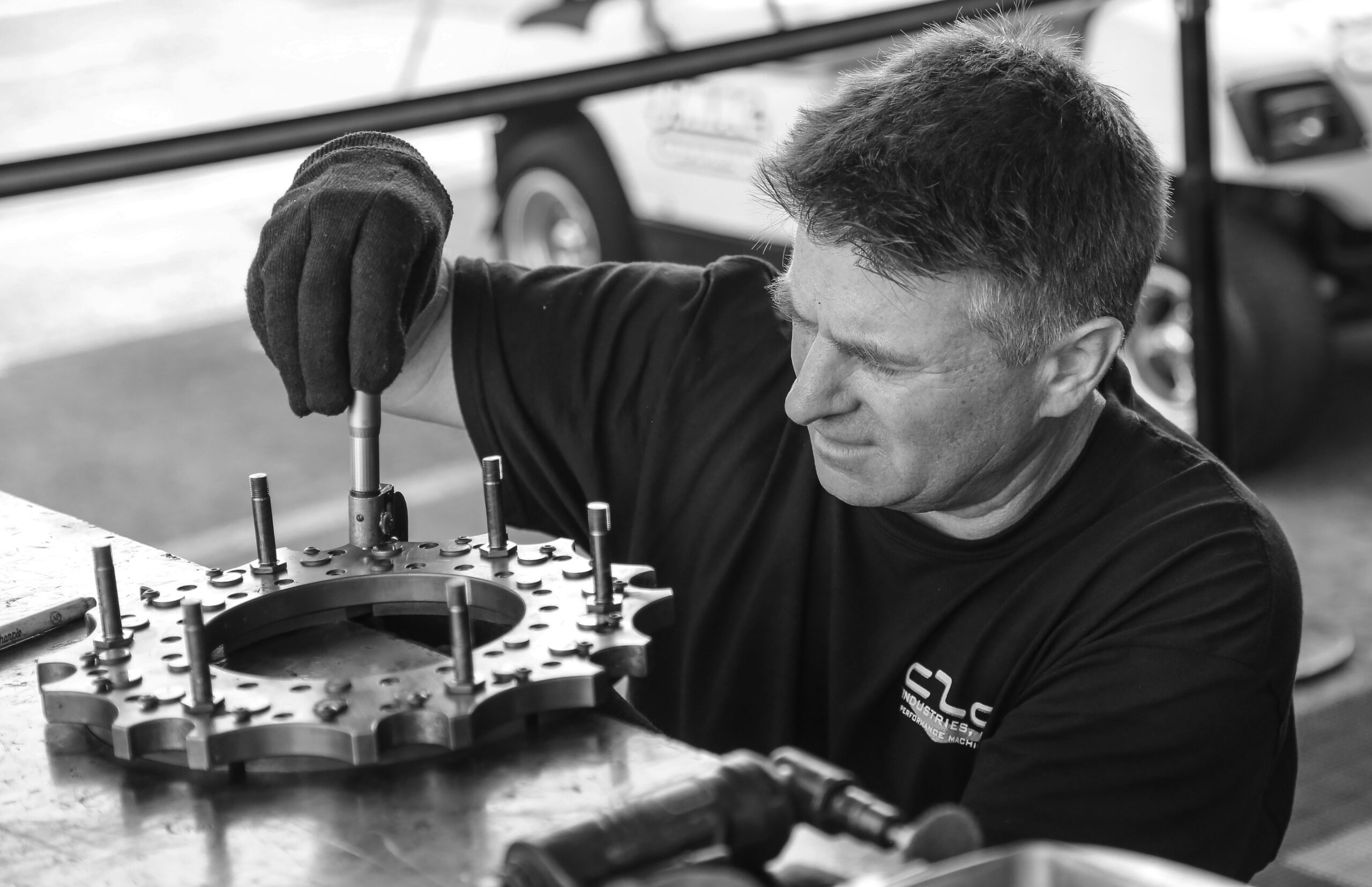 Maintenance technician inspecting industrial equipment on the plant floor, a common path to the maintenance manager role